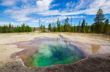 Fototapeta na wymiar Beautiful cinematic view of nature landscape in the American West under the blue cloudy sky. Geyser.
