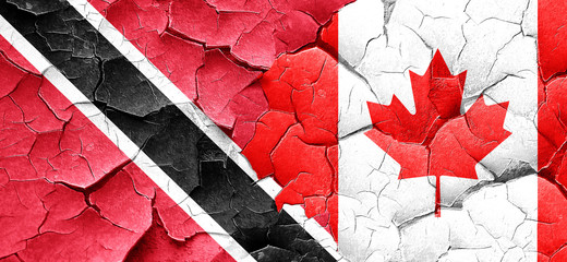 Trinidad and tobago flag with Canada flag on a grunge cracked wa
