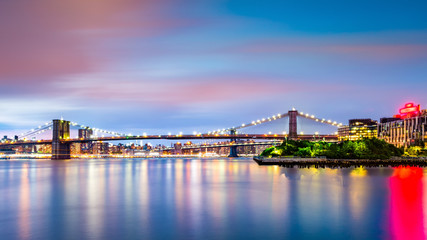 Fototapeta na wymiar Illuminated Brooklyn Bridge at dusk viewed from Pier2 park in New Yok City