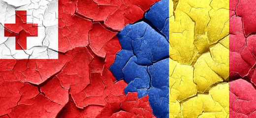 Tonga flag with Romania flag on a grunge cracked wall