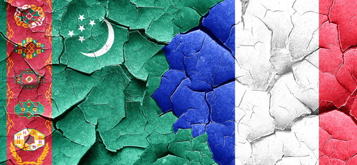Turkmenistan flag with France flag on a grunge cracked wall