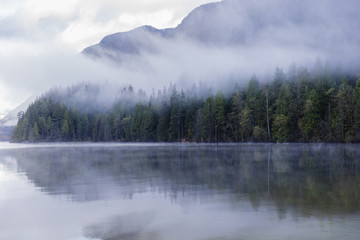 Foggy morning at the lake. Forest reflection. Forest fog. Cloudy weather. Cloudy morning. Forest and mountain. Vancouver nature. Pacific North West. Nature. Nature park. Early morning. Sunrise. 