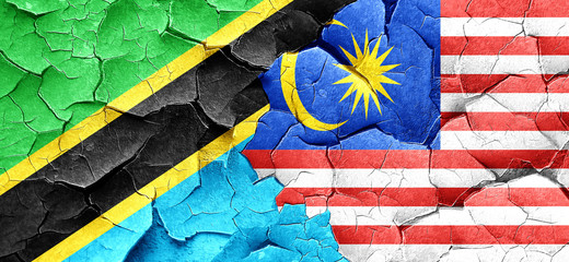 Tanzanian flag with Malaysia flag on a grunge cracked wall