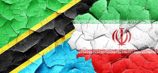 Tanzanian flag with Iran flag on a grunge cracked wall