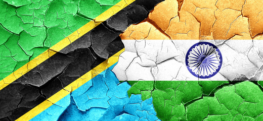 Tanzanian flag with India flag on a grunge cracked wall