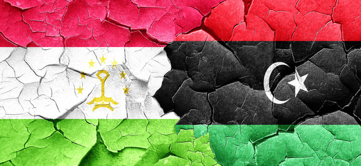 Tajikistan flag with Libya flag on a grunge cracked wall