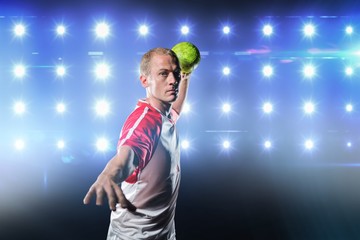 Sportsman throwing a ball against composite image of blue spotlight