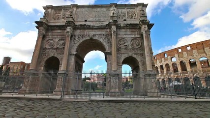 sunset with clouds in real time of Arch of Constantine, located between coliseum and the Arch of Titus on the Roman road, built to celebrate the triumph of the emperor Constantine. Rome, Italy.