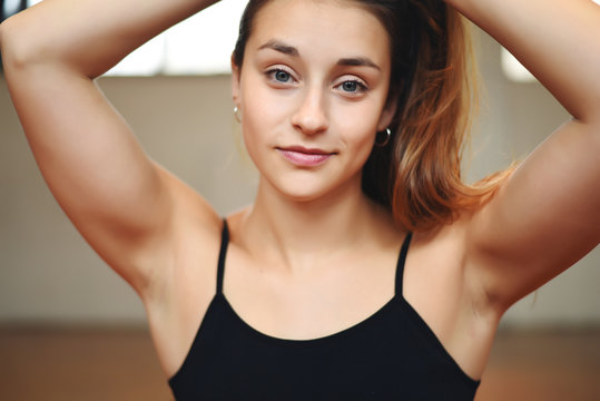 Close up of an athlete young woman at gym.
