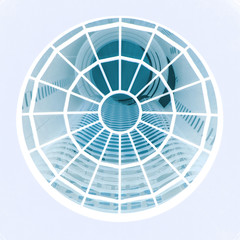 modern cylindrical architecture looking up though a round window like spiderweb