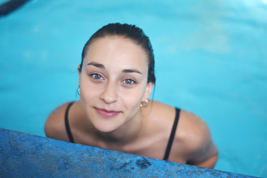 Portrait of young woman in a swimming pool.