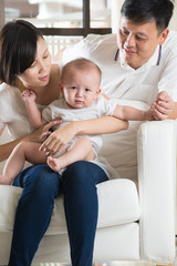 Obraz premium Happy Asian Family Playing with baby in the living room