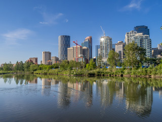 Fototapeta na wymiar Calgary skyline reflected in a reconstructed urban wetland along the Bow River.