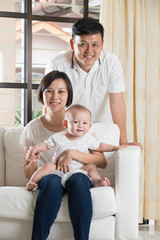 Happy Asian Family Playing with baby in the living room