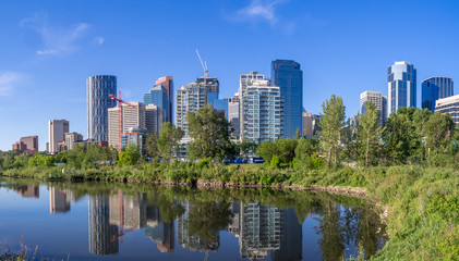 Fototapeta na wymiar Calgary skyline reflected in a reconstructed urban wetland along the Bow River.