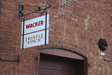 Wacker brewing and Thistle Finch Distillery signs