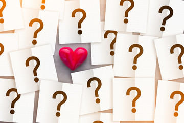 heart with note paper with question mark inside love concept.jpg