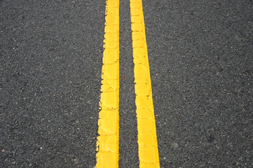 double yellow line on asphalt street surface