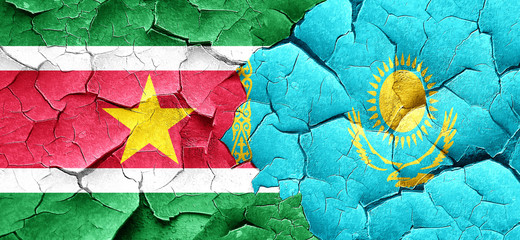 Suriname flag with Kazakhstan flag on a grunge cracked wall