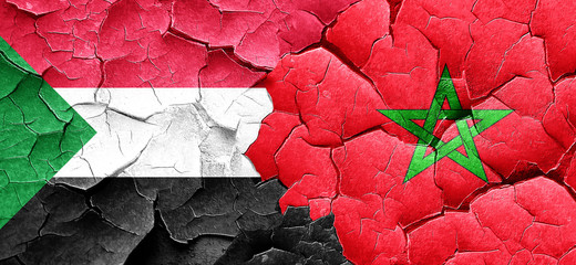 Sudan flag with Morocco flag on a grunge cracked wall