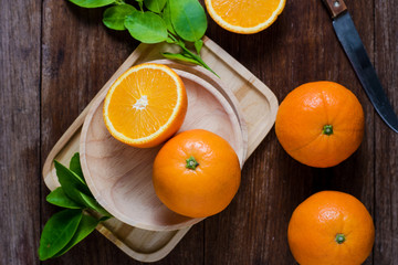 Fresh organic oranges fruits on wooden background.