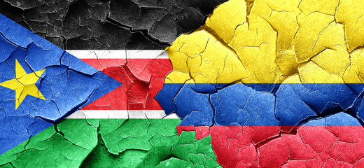 south sudan flag with Colombia flag on a grunge cracked wall