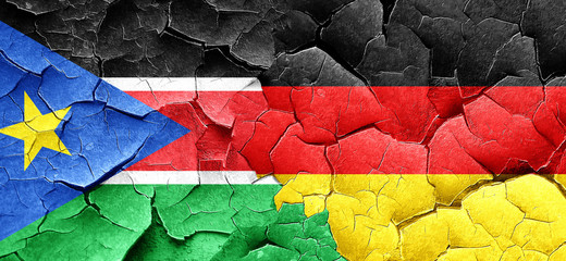 south sudan flag with Germany flag on a grunge cracked wall