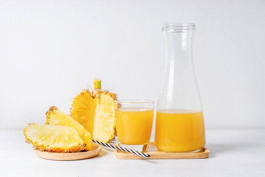 Pineapple slices and juice in glassware