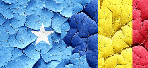 Somalia flag with Romania flag on a grunge cracked wall