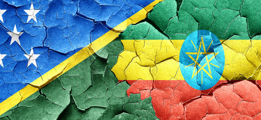 Solomon islands flag with Ethiopia flag on a grunge cracked wall