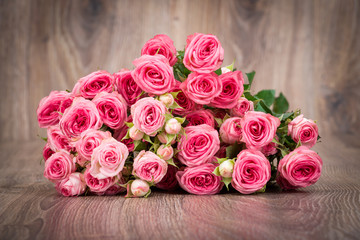 Roses on wooden background