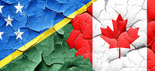 Solomon islands flag with Canada flag on a grunge cracked wall