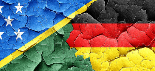 Solomon islands flag with Germany flag on a grunge cracked wall