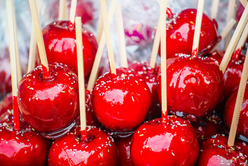 Sweet glazed red toffee candy apples on sticks