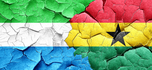 Sierra Leone flag with Ghana flag on a grunge cracked wall