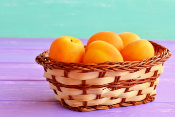 Sweet fresh apricots in basket. Organic orange fruits full of beta-carotene and fiber. Source of vitamins and minerals. Natural healthy vegetarian food, dessert. Stone fruits.
