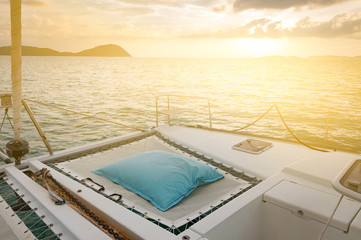 Fototapeta na wymiar Luxury catamaran yacht deck. Blue and white stripes mattress for