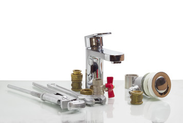 Mixer tap, plumber wrench, adjustable wrench and several plumbin