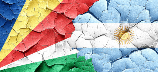 seychelles flag with Argentine flag on a grunge cracked wall