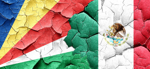 seychelles flag with Mexico flag on a grunge cracked wall