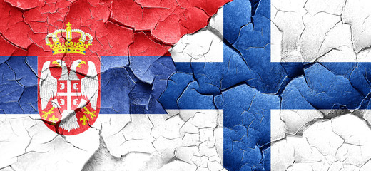 Serbia flag with Finland flag on a grunge cracked wall