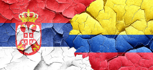 Serbia flag with Colombia flag on a grunge cracked wall