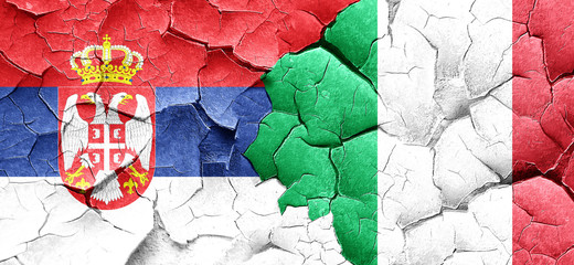 Serbia flag with Italy flag on a grunge cracked wall