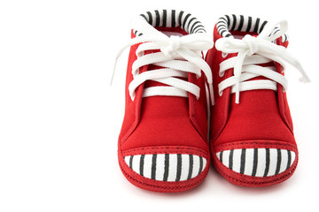 Red baby sneakers on white background