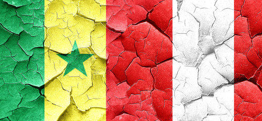 Senegal flag with Peru flag on a grunge cracked wall