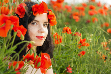 Girl in a field of poppies