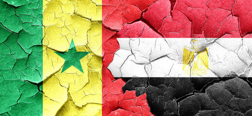 Senegal flag with egypt flag on a grunge cracked wall