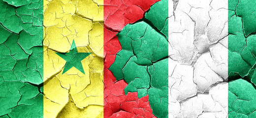 Senegal flag with Nigeria flag on a grunge cracked wall