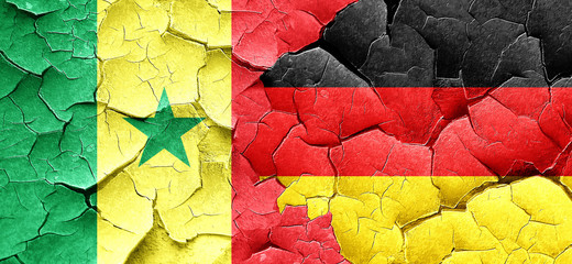 Senegal flag with Germany flag on a grunge cracked wall