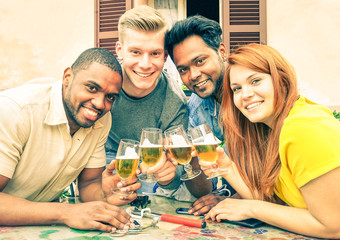 Cheerful multiethnic teens holding drinks glasses at street  bar - Concept of fun and friendship 